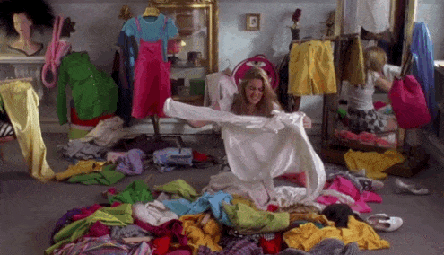 Giphy clip of young woman sorting through a cluttered bedroom, frustrated.