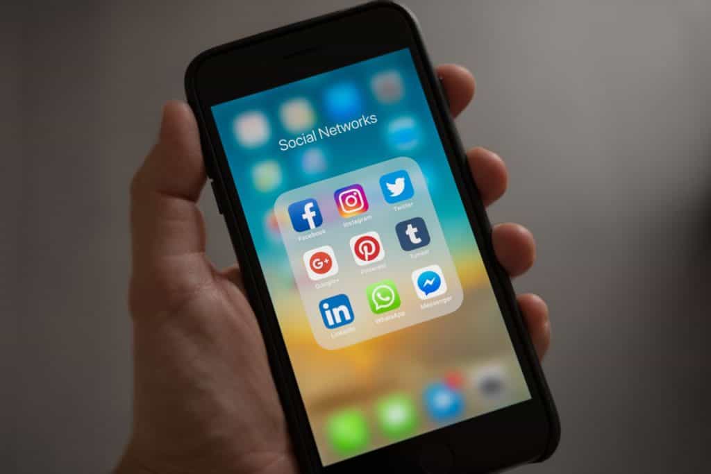 Iphone showing social media apps including Twitter, LinkedIn, and Facebook.